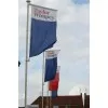 Banner head with rotating arm for fiberglass flagpole