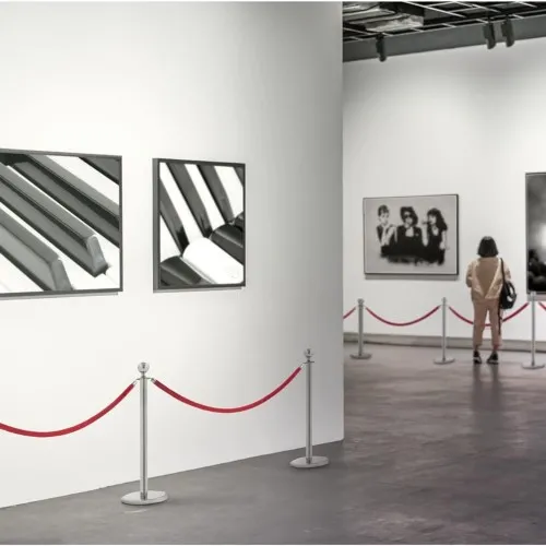 Pair of two silver barrier post and one red rope
